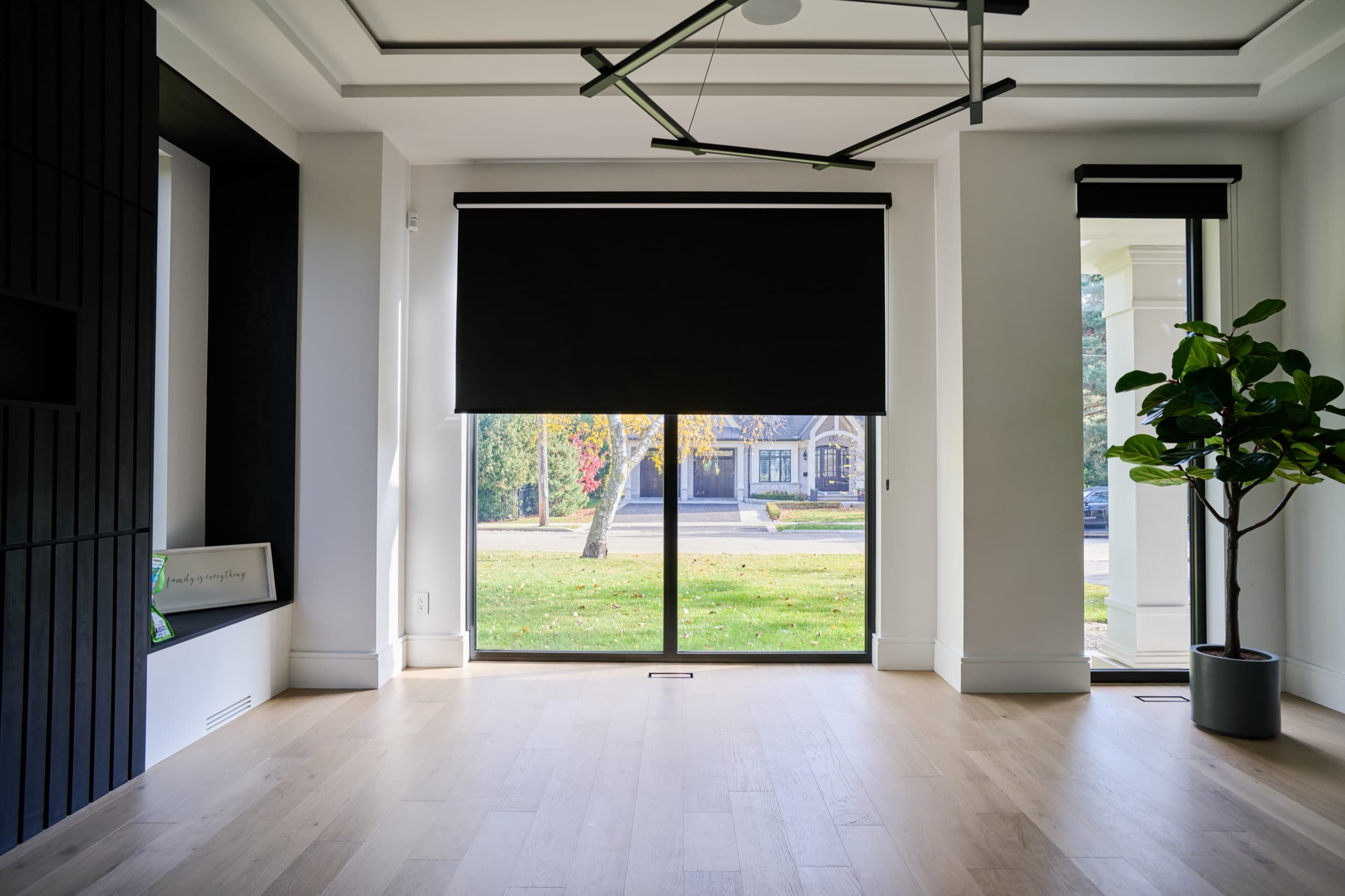 Custom black roller shades installed in a bright Texas home